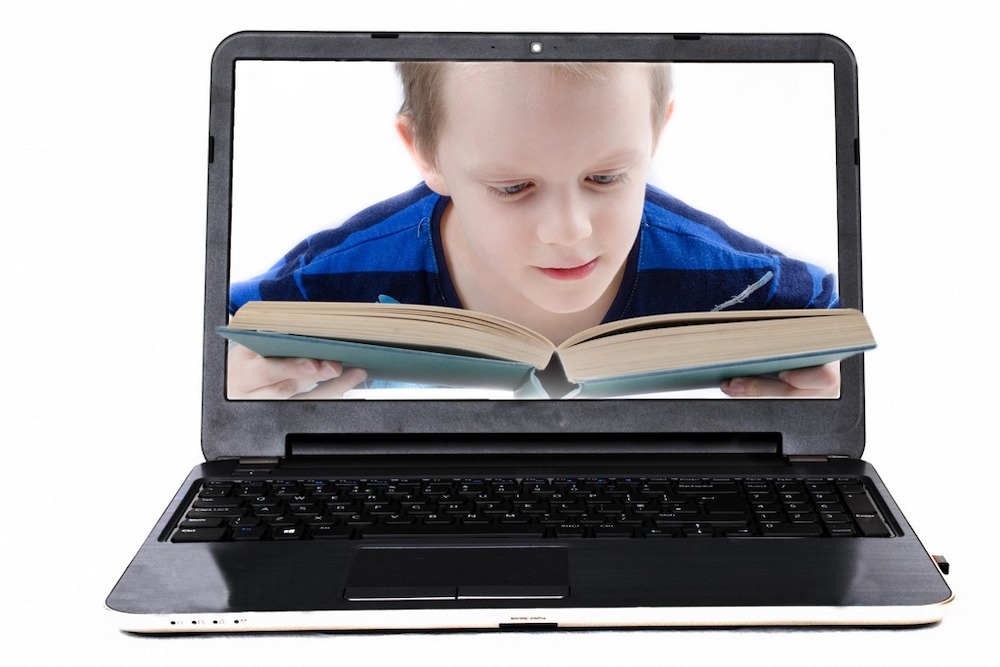 Photo montage : un enfant lit un livre dans l'écran d'un portable