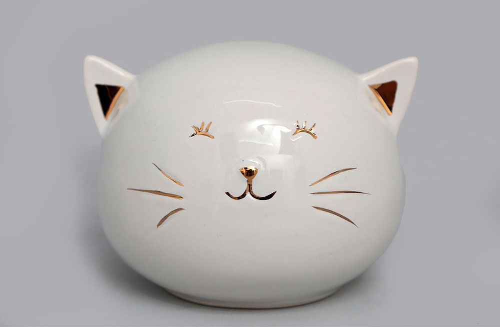 Tireline en porcelaine, chat blanc et doré